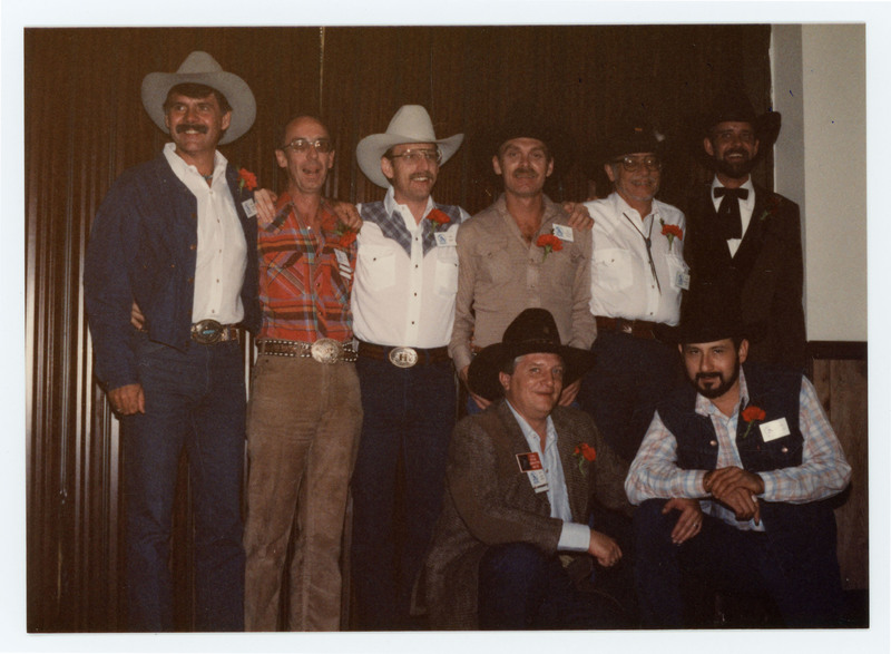 Group of men in cowboy hats posing
